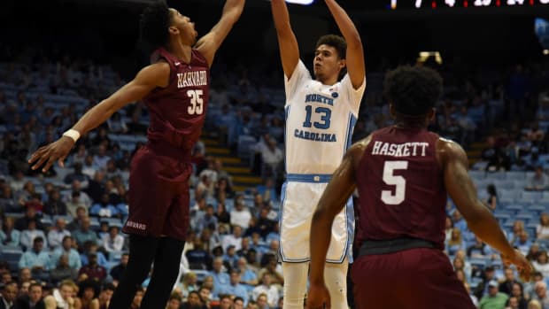 Jan 2, 2019; Chapel Hill, NC, USA; North Carolina Tar Heels guard Cameron Johnson (13) shoots over Harvard Crimson forward Robert Baker (35) during the second half at Dean E. Smith Center. The Tar Heels won 77-57. Mandatory Credit: Rob Kinnan-USA TODAY Sports